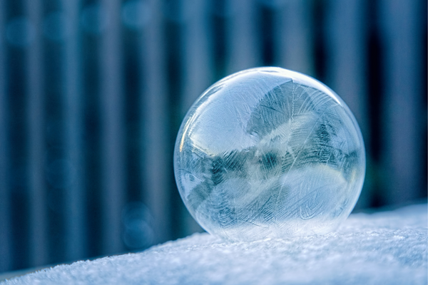 Close-up of a frosted glass bubble with ice crystal patterns