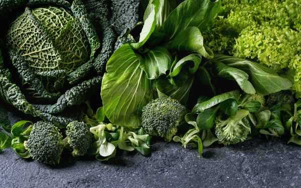 Close-up of dark leafy greens including cabbage, lettuce and broccoli