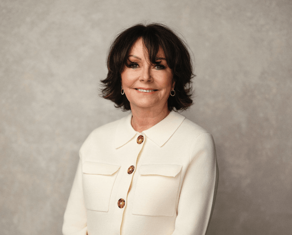 Portrait of a smiling woman in a white jacket for a free webinar