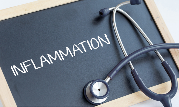 Chalkboard with the word INFLAMMATION written in chalk beside a stethoscope