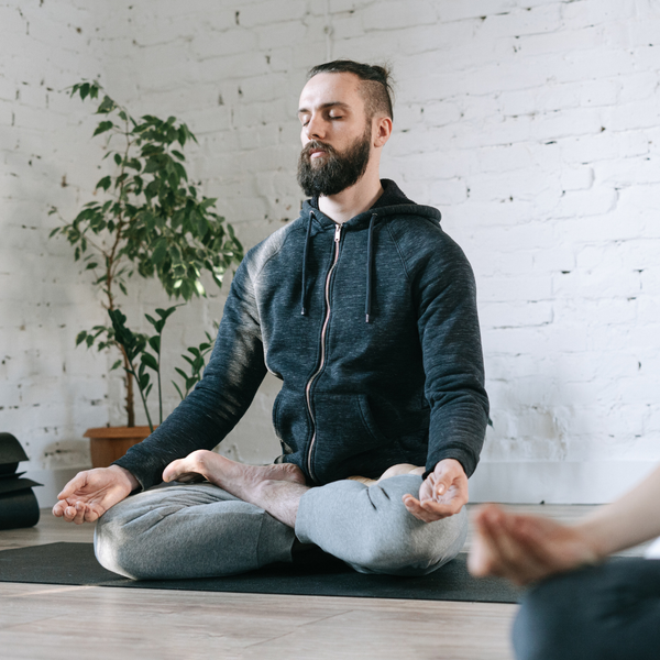 Man sitting cross-legged in a meditative yoga pose