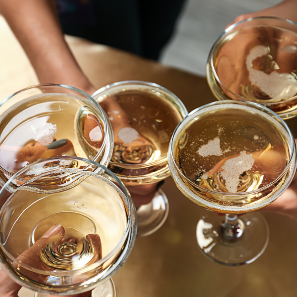 Group of people clinking glasses of champagne together