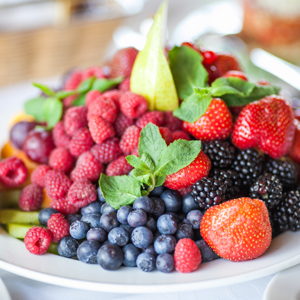 Plate of mixed berries including raspberries, blueberries, strawberries and blackberries