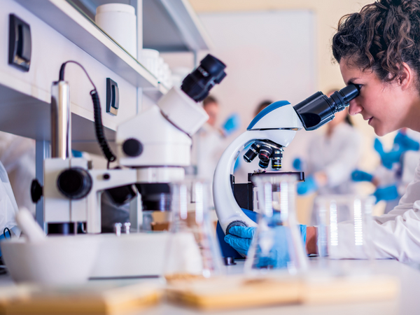 Scientist looking through a microscope in a laboratory