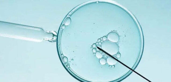 Petri dish with bubbles and a pipette and needle on a light blue background