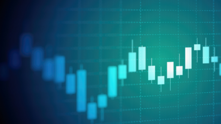 Candlestick chart with teal and blue tones displayed on a dark gradient background