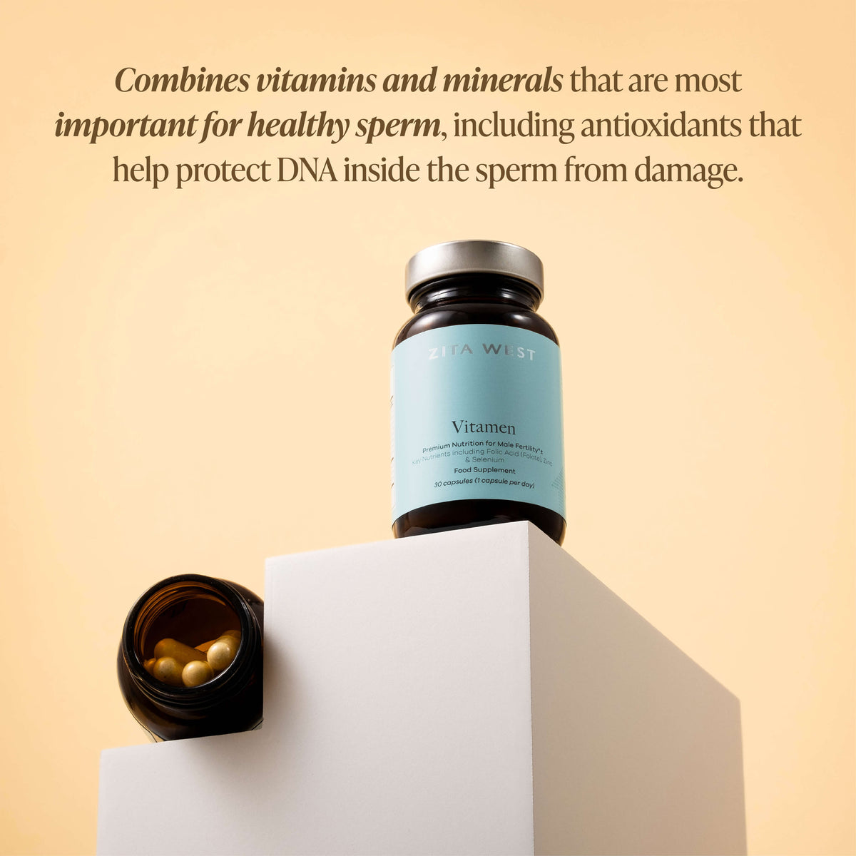 Zita West Vitamen bottle on a white plinth beside an open jar of gold capsules