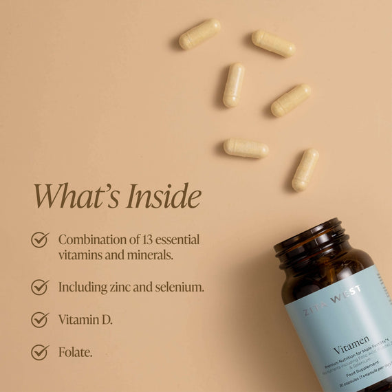Zita West Vitamen capsules spilling from an open amber glass bottle onto a beige background, with text listing key ingredients