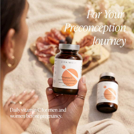 Person holding a bottle of Zita West Vitamin C supplement with text about the preconception journey