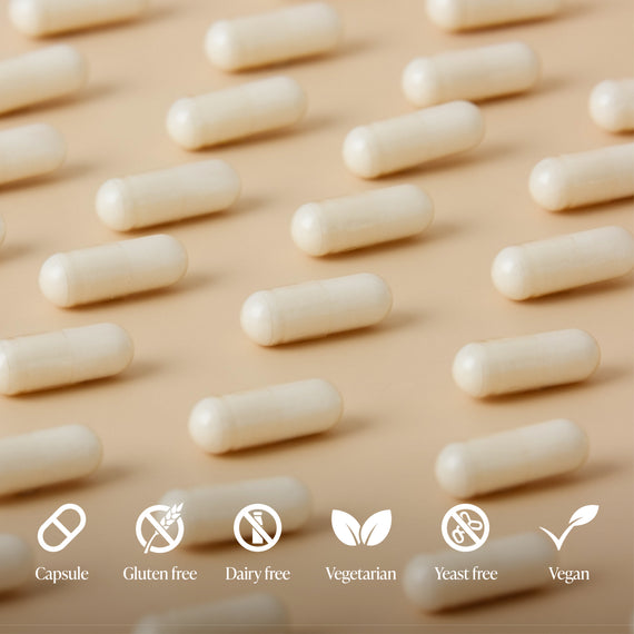 White capsules arranged in rows on a beige background with dietary label icons.