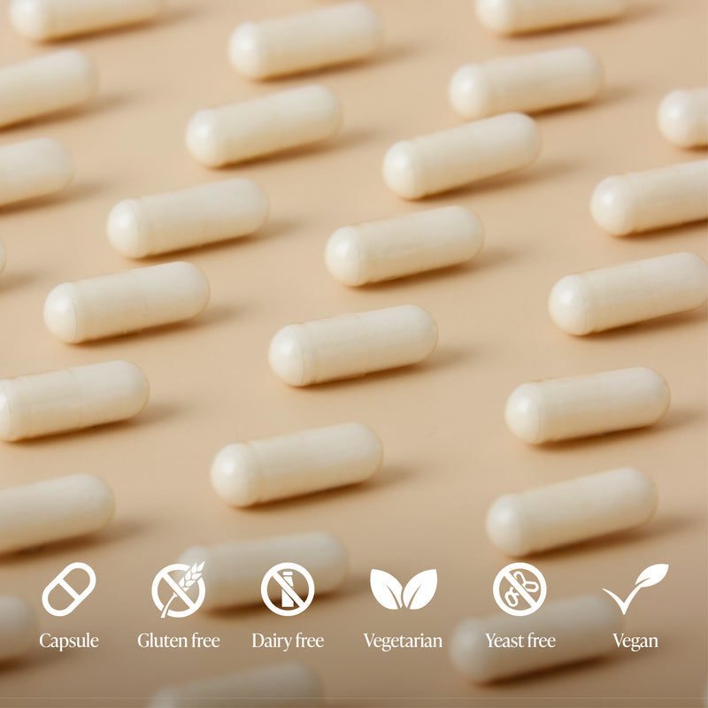 White capsules arranged in rows on a beige background with dietary label icons.