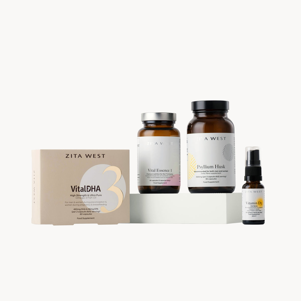 Collection of trimester one supplements including capsules, oils, and a box on a white background