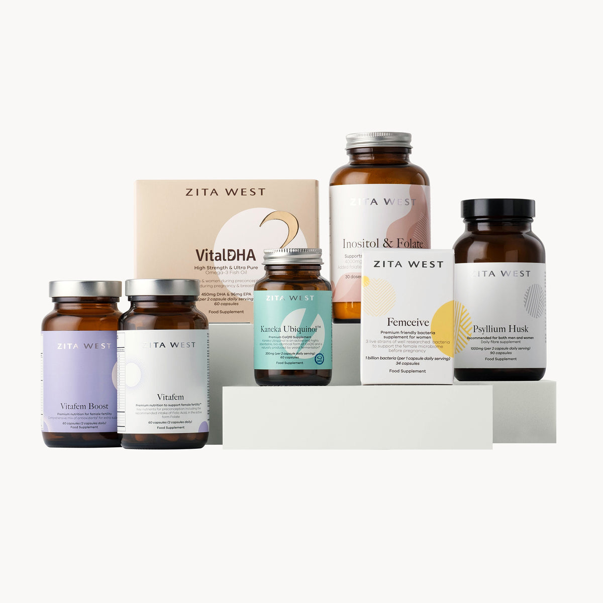 Collection of Zita West supplement bottles and boxes which support egg health on a white background